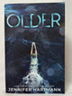 Cover of Older (Deluxe Edition) by Jennifer Hartmann, Paperback (Bloom Books)