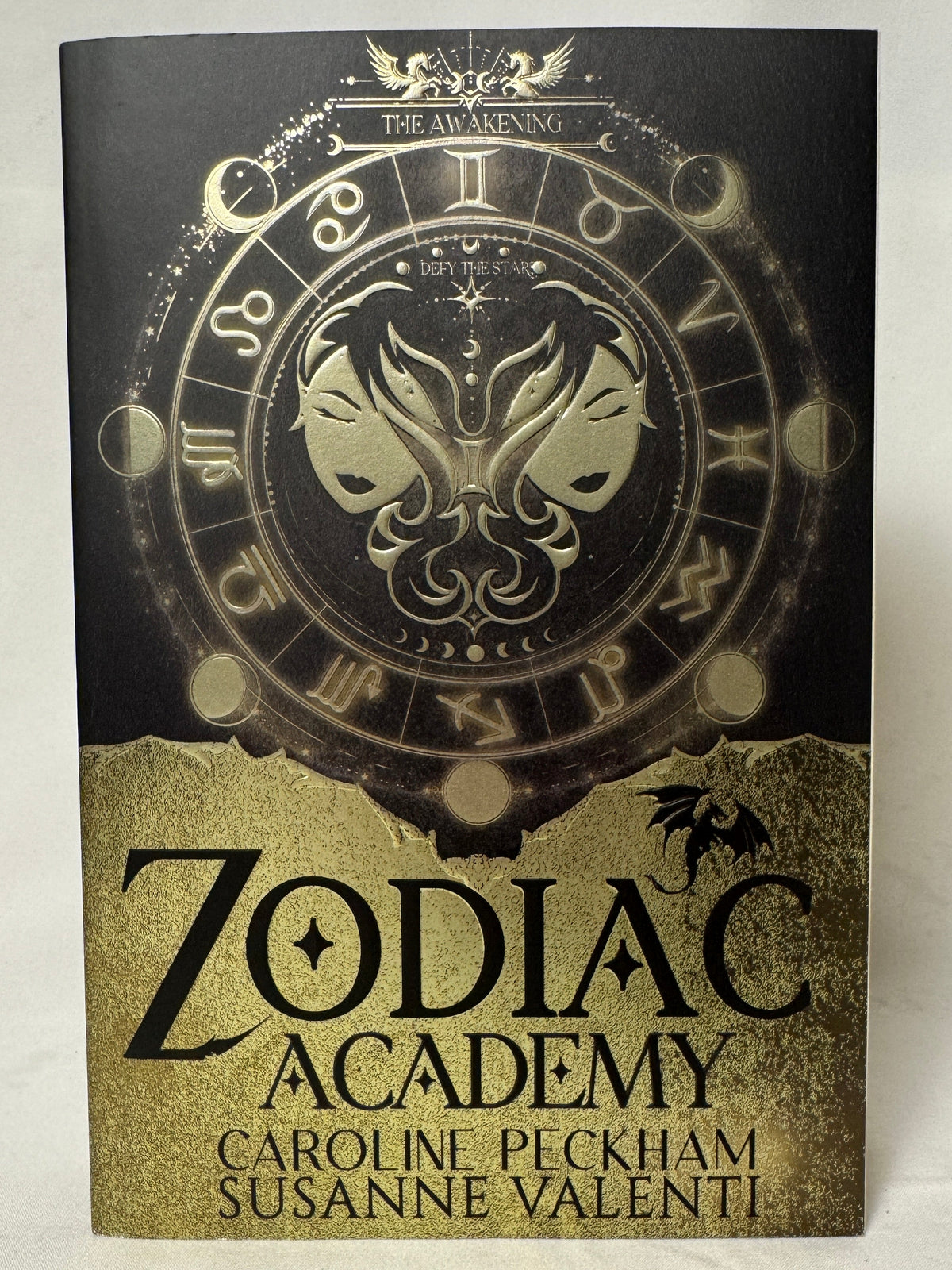 Cover of Zodiac Academy 1: The Awakening by Caroline Peckham & Susanne Valenti, Paperback Re-Issue with Bonus Chapter