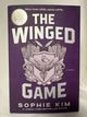 Cover of The Winged Game by Sophie Kim, First Edition Hardcover with Sprayed Edges